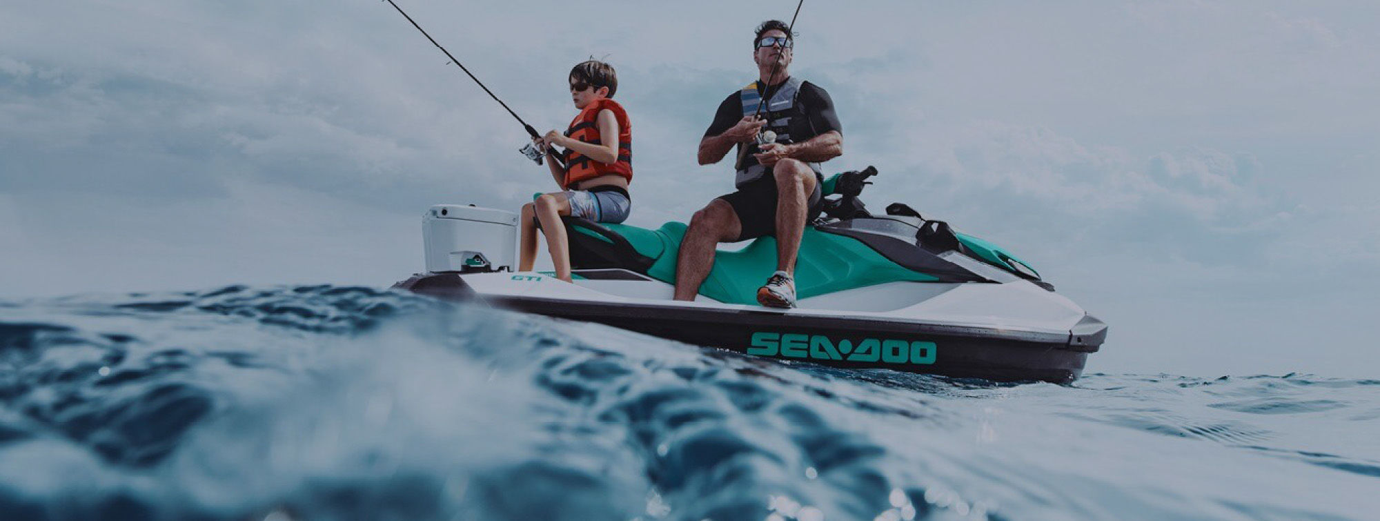 Father and son fishing on a jet ski